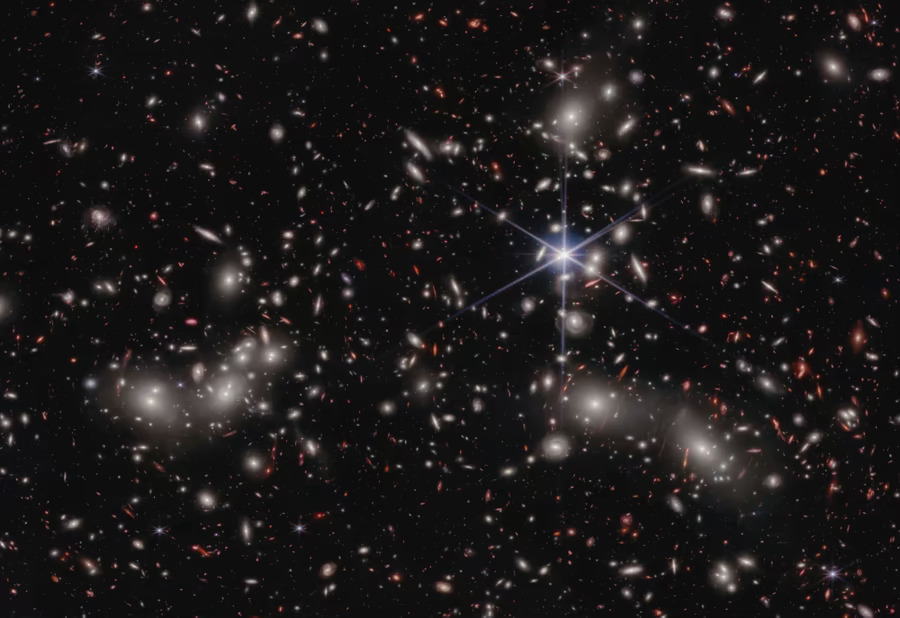 A dazzling image of a celestial Christmas tree captured by Hubble and Webb telescopes