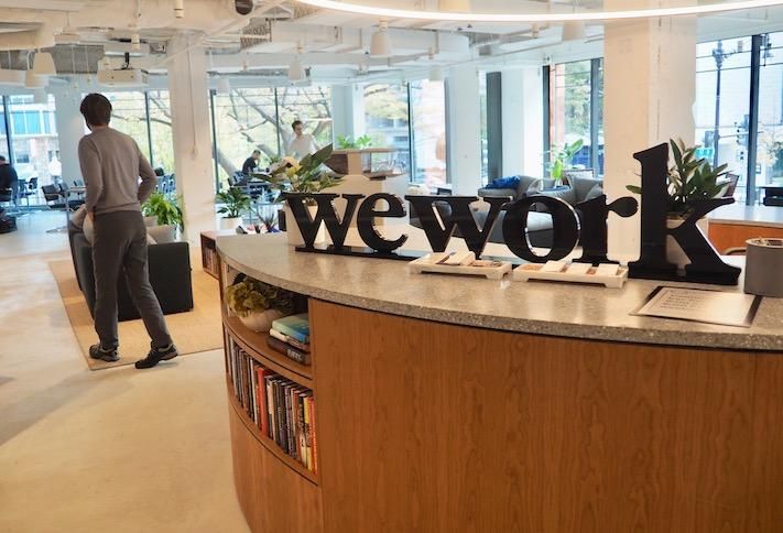 A bustling WeWork office during peak growth, showcasing entrepreneurial spirit